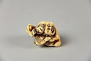 Netsuke of Acrobat Removing his Hat with His Foot by Unknown Artist