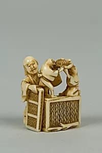 Netsuke of Man Training Birds by Unknown Artist