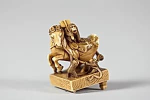Netsuke of a Horse on a Pedestal with Monkeys Playing About by Unknown Artist