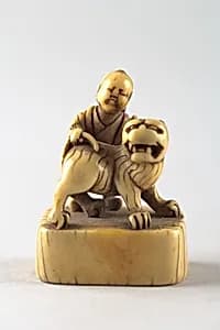 Netsuke of Boy with Dog by Unknown Artist