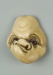 Netsuke of Mask with Man's Lopsided Face by Unknown Artist