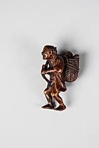Netsuke of Man Carrying Basket of Fish by Unknown Artist