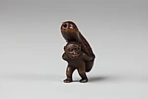 Netsuke of Monkey Carrying a Cucumber on His Back by Unknown Artist