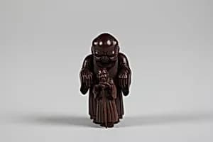 Netsuke of Ghost Trying in Vain to Frighten Blind Man by Unknown Artist