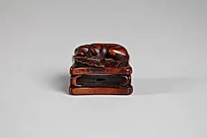 Netsuke of Dog and Fan on a Bench by Unknown Artist