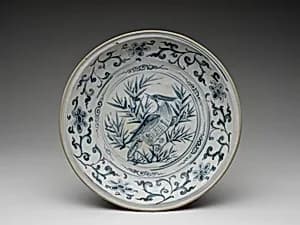 Dish with bird amid bamboo design and foliate meander on cavetto by Unknown Artist