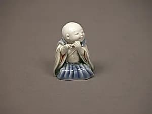 染付色絵囃子唐子形置物|Chinese child with musical instrument by Unknown Artist