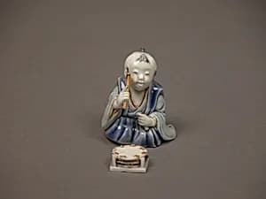 染付色絵囃子唐子形置物|Chinese child with musical instrument by Unknown Artist