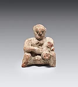 Figurine of a seated man by Unknown Artist