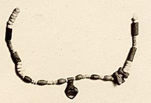 Necklace of beads and amulets by Unknown Artist