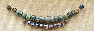 String of 11 Eyed Beads by Unknown Artist