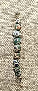 String of 12 Eyed Beads by Unknown Artist