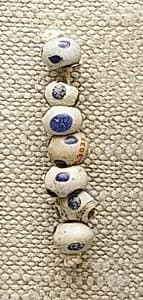 String of 7 Eyed Beads by Unknown Artist