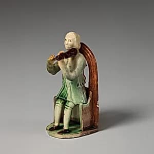 Man playing a fiddle by Astbury-Whieldon