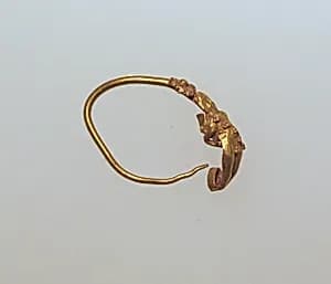 Gold earring with figure by Unknown Artist