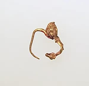 Gold earring with figure by Unknown Artist
