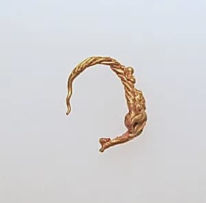 Gold earring with figure by Unknown Artist