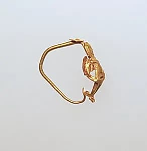 Gold earring with winged figure by Unknown Artist