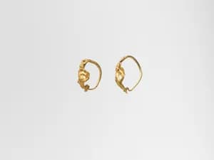Gold earring with winged figure by Unknown Artist