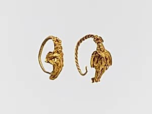 Gold earring with winged figure by Unknown Artist