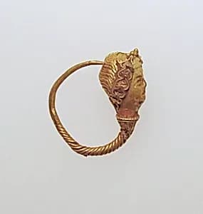 Gold earring with woman's head by Unknown Artist