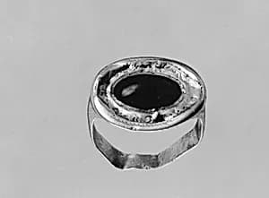 Gold ring with a garnet by Unknown Artist