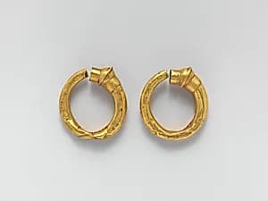 Gold trumpet-shaped earrings by Unknown Artist