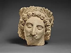Limestone head of Apollo by Unknown Artist