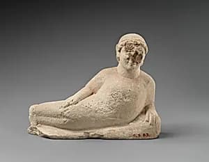 Limestone male banqueter by Unknown Artist