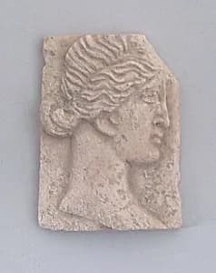 Relief of a head of woman by Unknown Artist