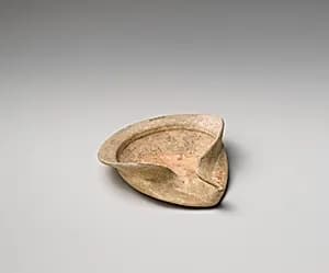 Terracotta saucer-shaped oil lamp by Unknown Artist