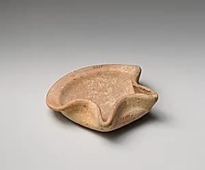 Terracotta saucer-shaped oil lamp by Unknown Artist