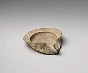 Terracotta saucer-shaped oil lamp by Unknown Artist