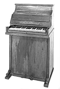 Upright piano and reed organ by Unknown Artist