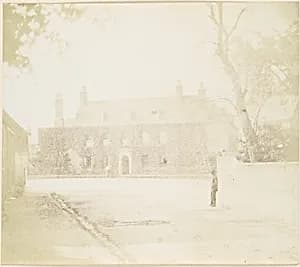 [Man in Courtyard Before House] by Unknown