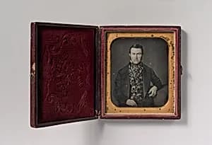 [Seated Man in Floral Vest]