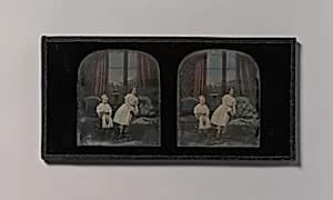 [Stereograph, Two Children Standing Between Furniture in a Studio Parlor Setting] by Antoine-François-Jean Claudet