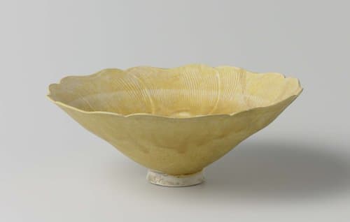 Bowl in the shape of a flower with a yellow glaze by anonymous