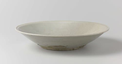 Saucer-dish with an incised landscape and foliate decoration by anonymous