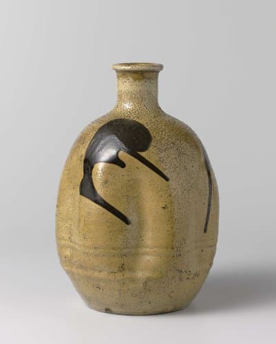Ovoid sake bottle with a yellow glaze and brown marks by anonymous