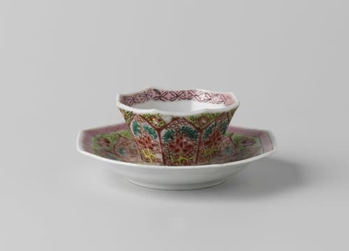 Octagonal cup and saucer with foral scrolls in petal-shaped panels by anonymous