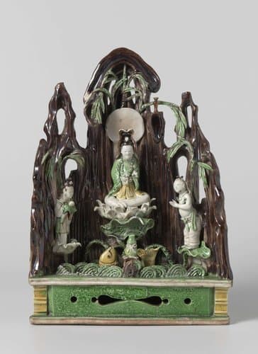 Guanyin seated on a lotus throne with two servants by anonymous