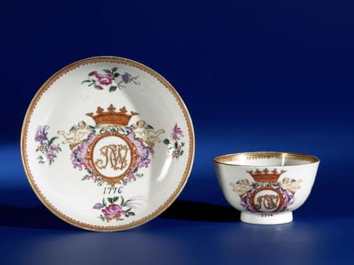 Cup and saucer with a crowned monogram and flower sprays by anonymous
