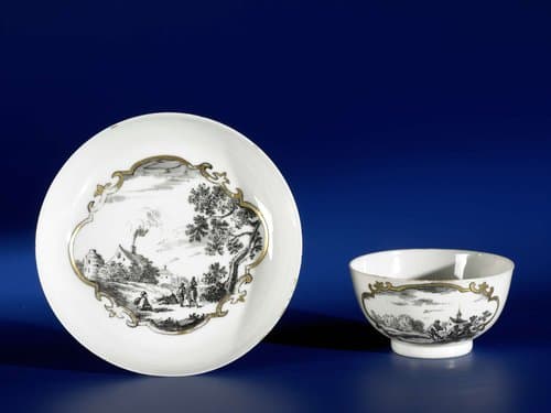 Straight-sided cup and saucer with European landscapes in panels by anonymous