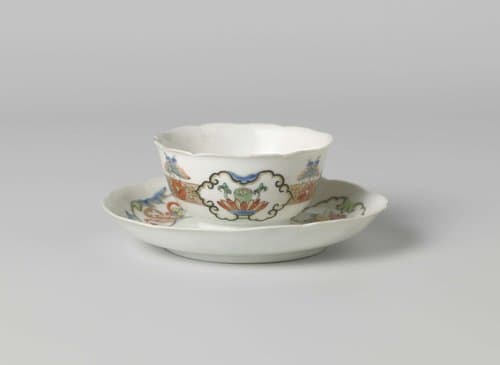 Bell-shaped cup and saucer with butterflies, floral scrolls and auspicious objects in panels by anonymous