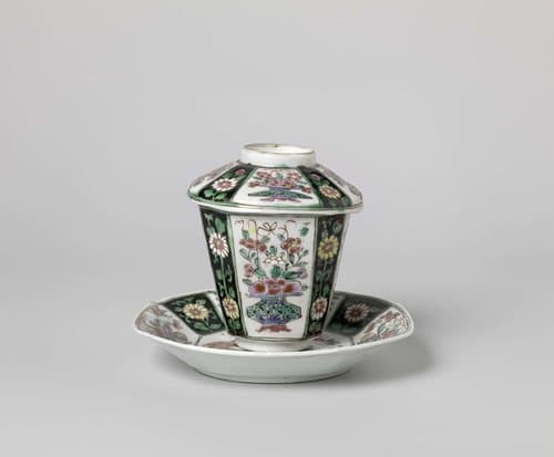 Covered cup and saucer with flower baskets and floral scolls by anonymous