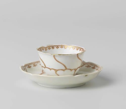 Cup and saucer with stylized flower and ornamental border by anonymous
