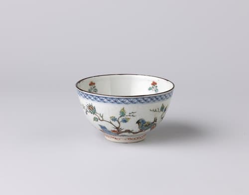 Bowl with insiced floral scrolls and a tree with parrots by anonymous