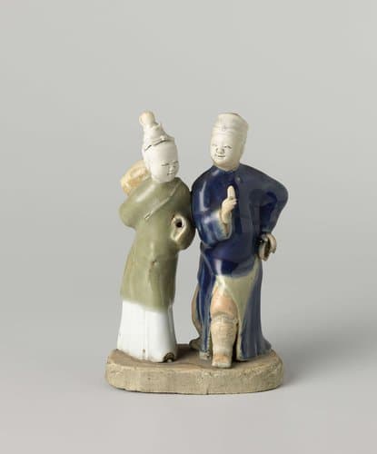 Figure of a walking man and woman with musical instruments by anonymous