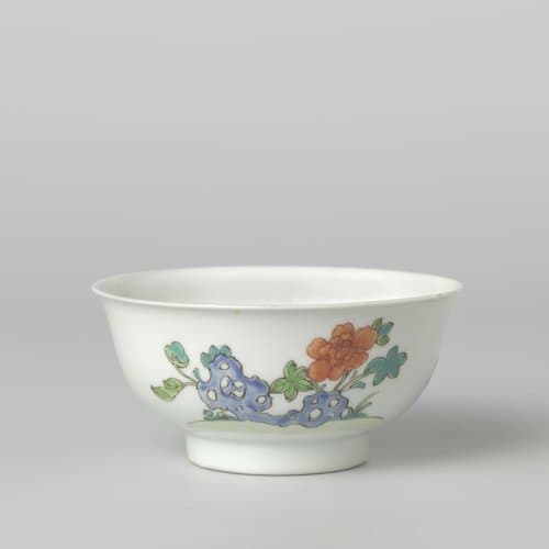Bell-shaped bowl with flower sprays and a flowering plant near a rock by anonymous